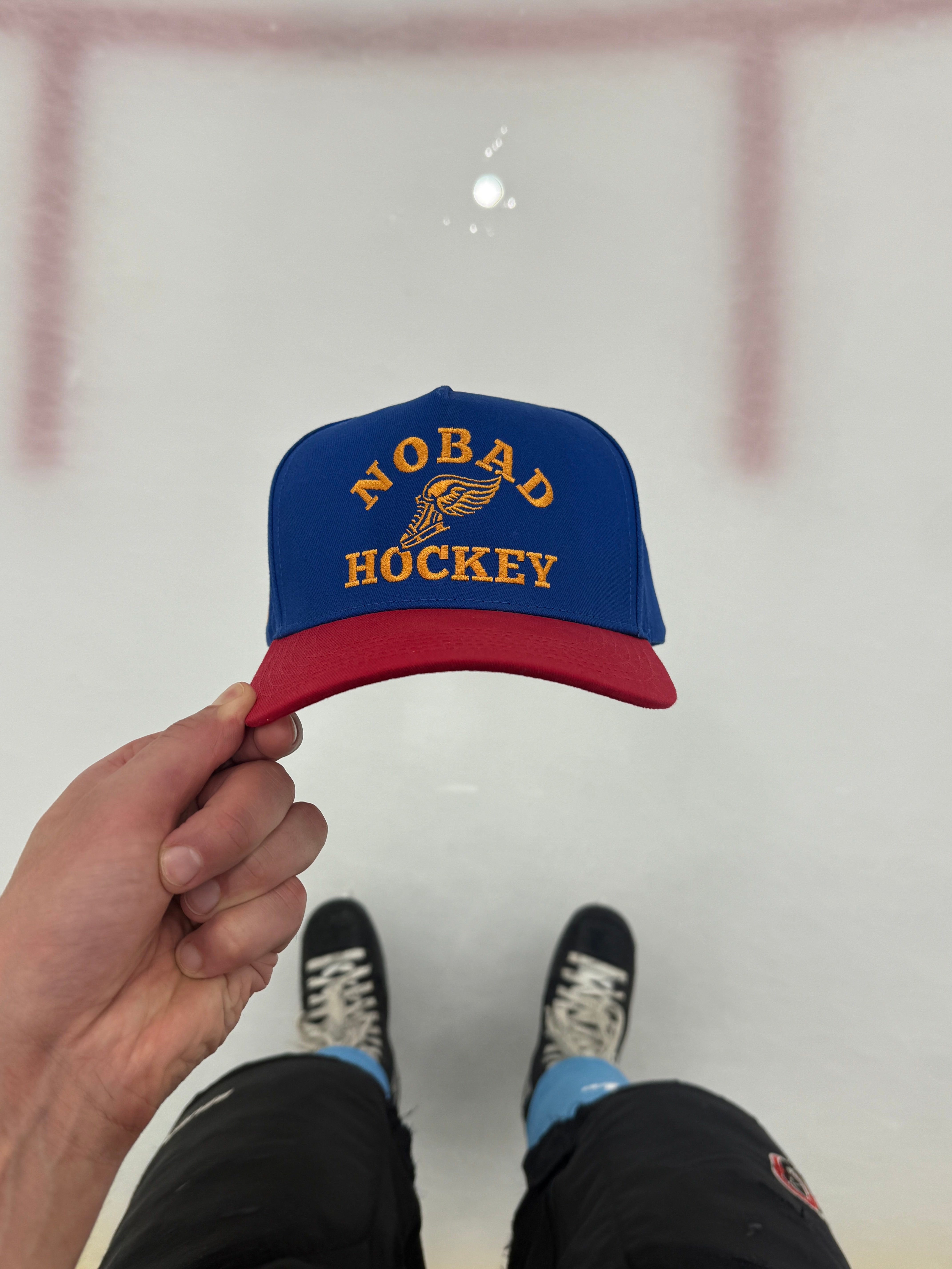 Vintage Hockey Hat Off-Campus held up at the rink