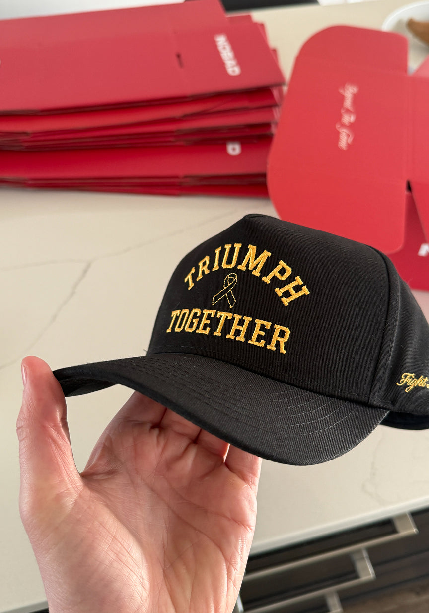 Black Triumph Together hat with gold embroidery and Fight Like A Kid side detail