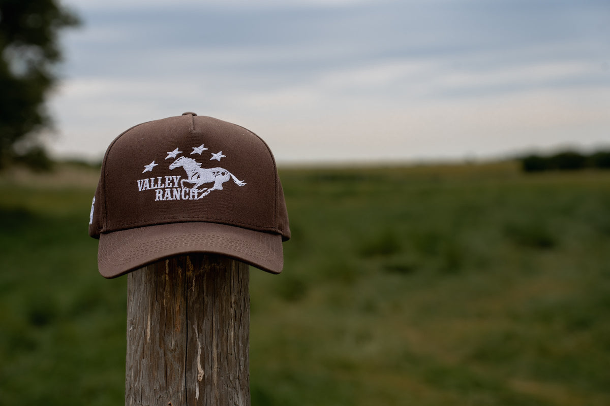 Valley Ranch hat on a fence post in a Pembina Valley field